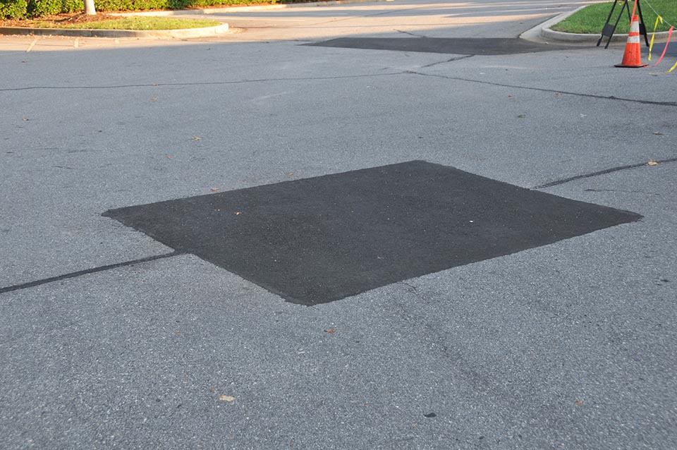 A new square section of asphalt to help illustrate asphalt crack repair