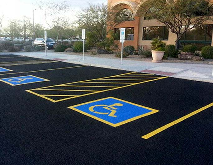ADA handicap parking painting on a new commercial asphalt parking lot to help illustrate Asphalt Paving Hillsboro and Asphalt Paving Clackamas and asphalt paving Gresham and Asphalt vs. Concrete Parking Lot