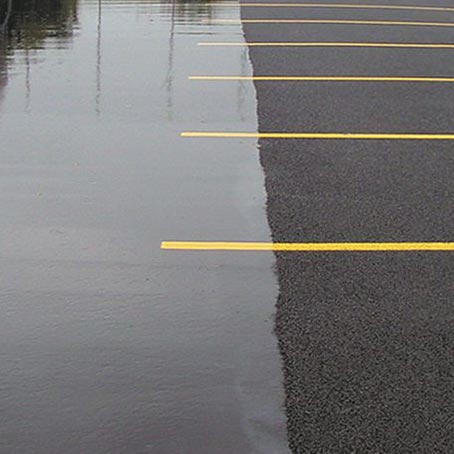 An image of permeable asphalt parking lot to help illustrate green paving