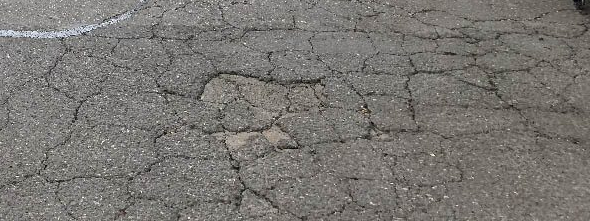 Severely cracked asphalt to illustrate diy asphalt repair